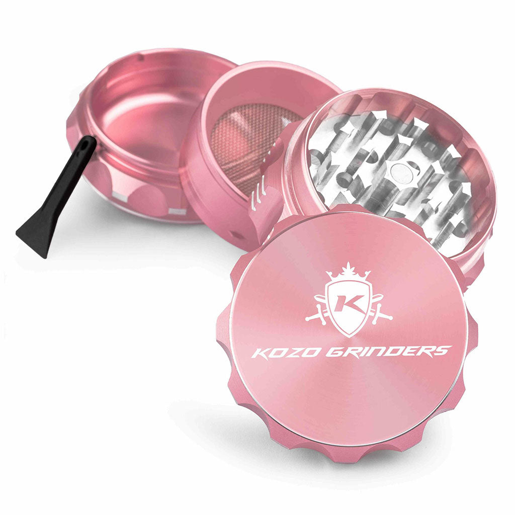 Kozo 2 inch four-piece aluminum grinder in rose gold, split into four pieces with the pollen scraper