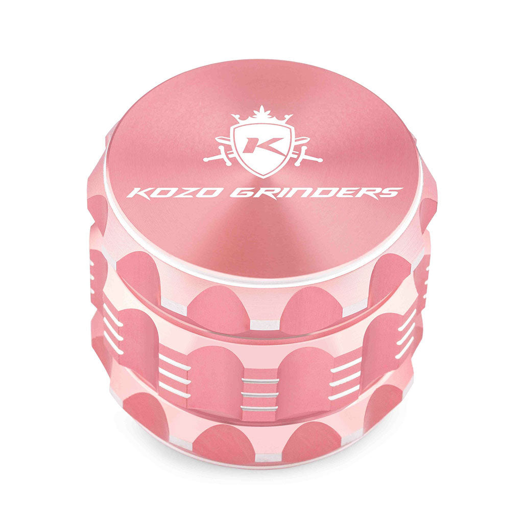 Kozo 2 inch four-piece aluminum grinder in rose gold, closed front view of the body with the Kozo logo lid