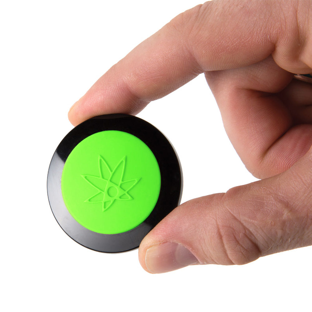 420 Science Wax Wallet in hand, green and black silicone, portable 1.75" x 0.5" concentrate storage