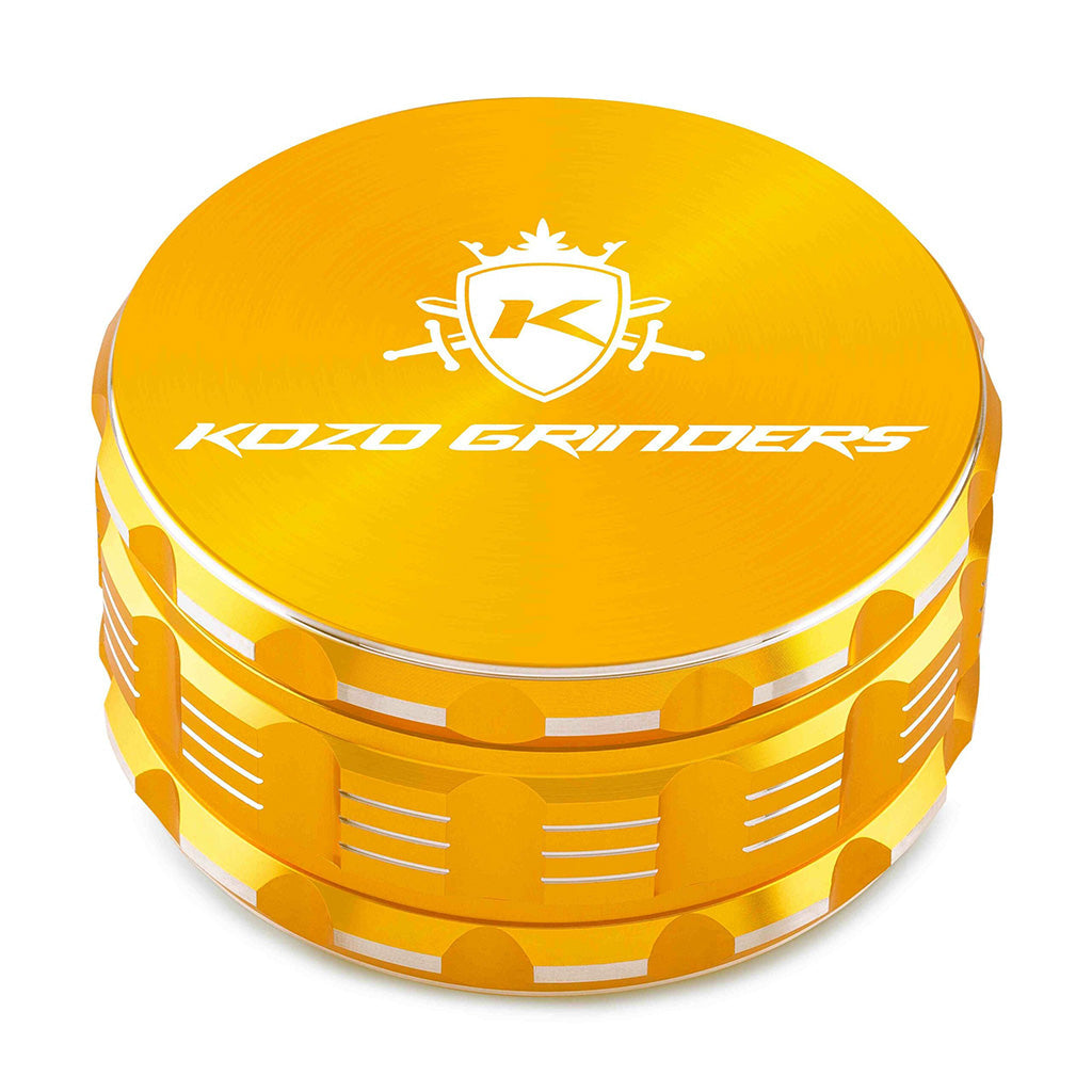 Kozo 4 inch four-piece anodized aluminum grinder in gold, closed front view of the body with the Kozo logo lid