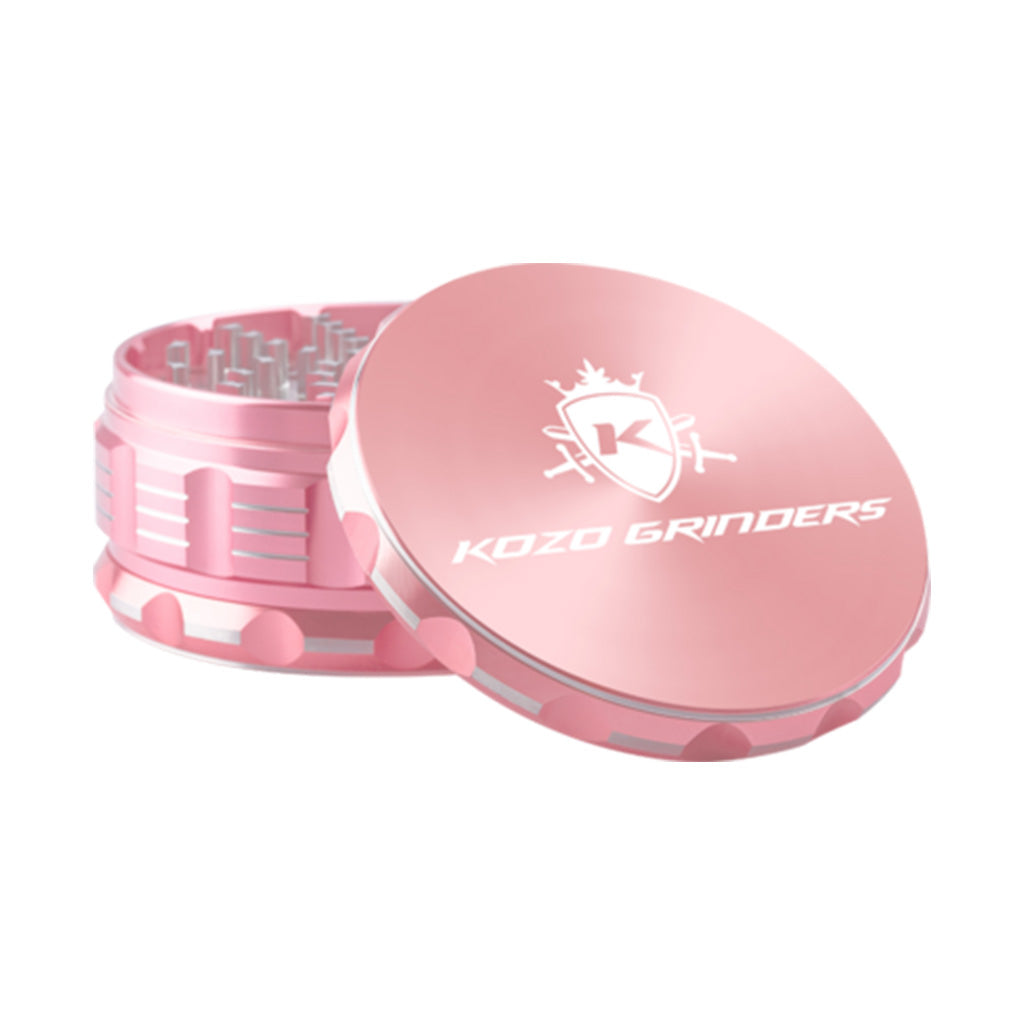 Kozo 4 inch four-piece anodized aluminum grinder in rose gold, lid tilted open beside the toothed grinding chamber