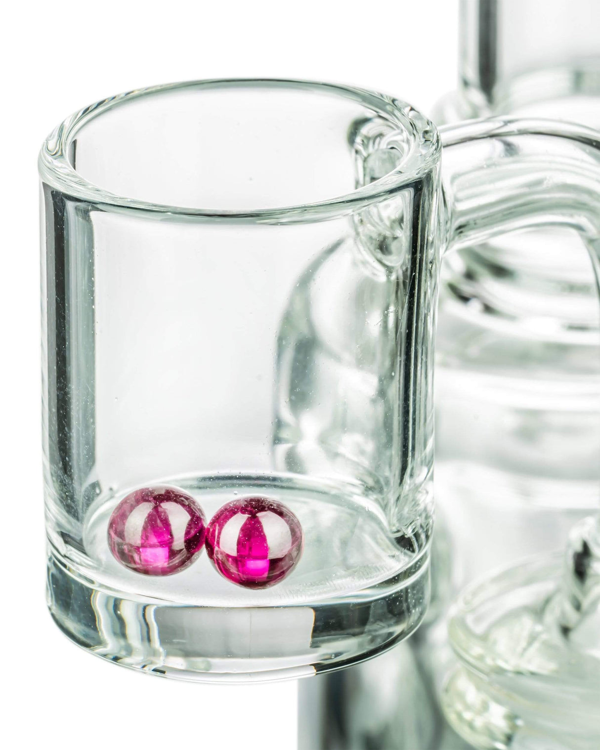 Close-up of 4mm Ruby Terp Pearls for Dab Rigs, red color, resting in clear glass dish