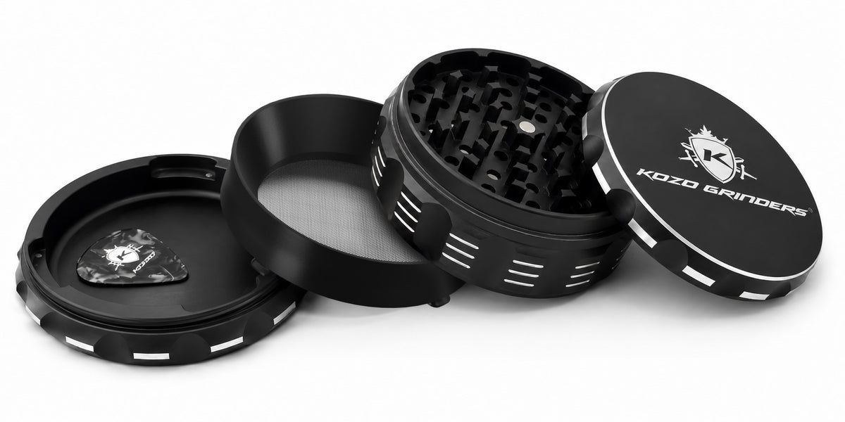 Kozo 4 inch four-piece non-stick aluminum grinder in black, taken apart into lid, body, screen ring and kief base