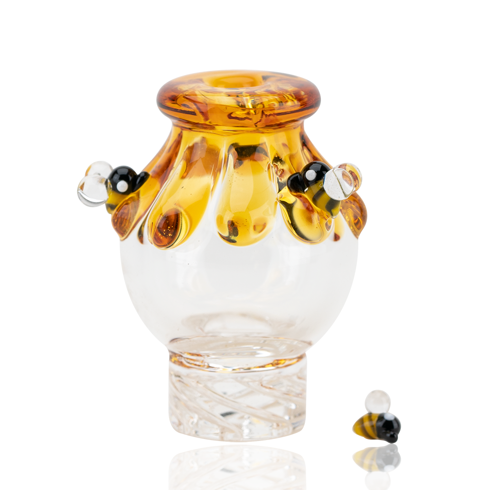 Empire Glassworks Beehive Spinner Cap with intricate honey drip design, front view on white background