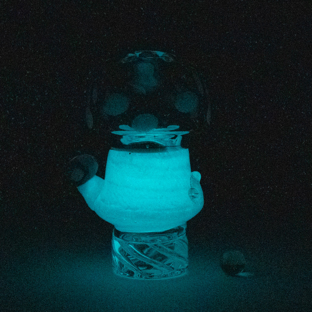 Empire Glassworks Siriusly Shrooms Spinner Cap glowing in dark, front view on black background