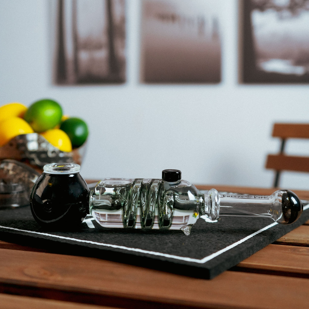 Freeze Pipe hand pipe with black accents, glycerin chamber, and borosilicate glass, on table