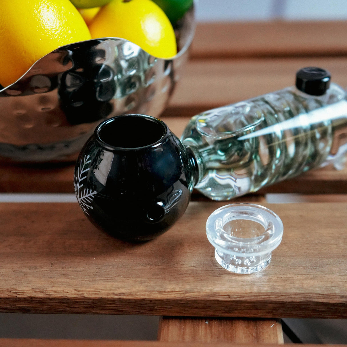 Freeze Pipe hand pipe in black, portable glycerin-cooled spoon pipe, 6" length on wooden table