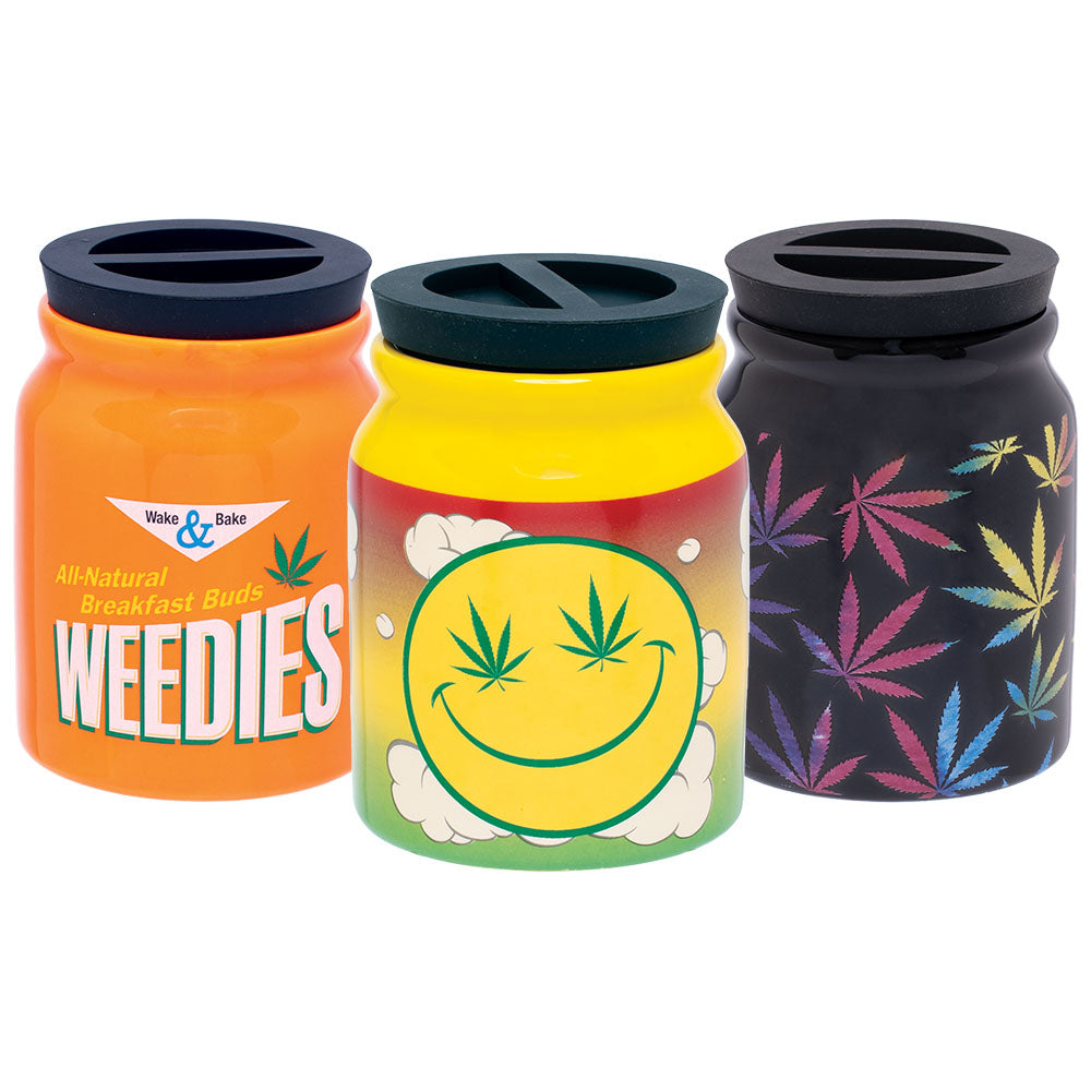 Fujima Happy Hemp Ceramic Stash Jars in orange, yellow, and black with cannabis leaf designs