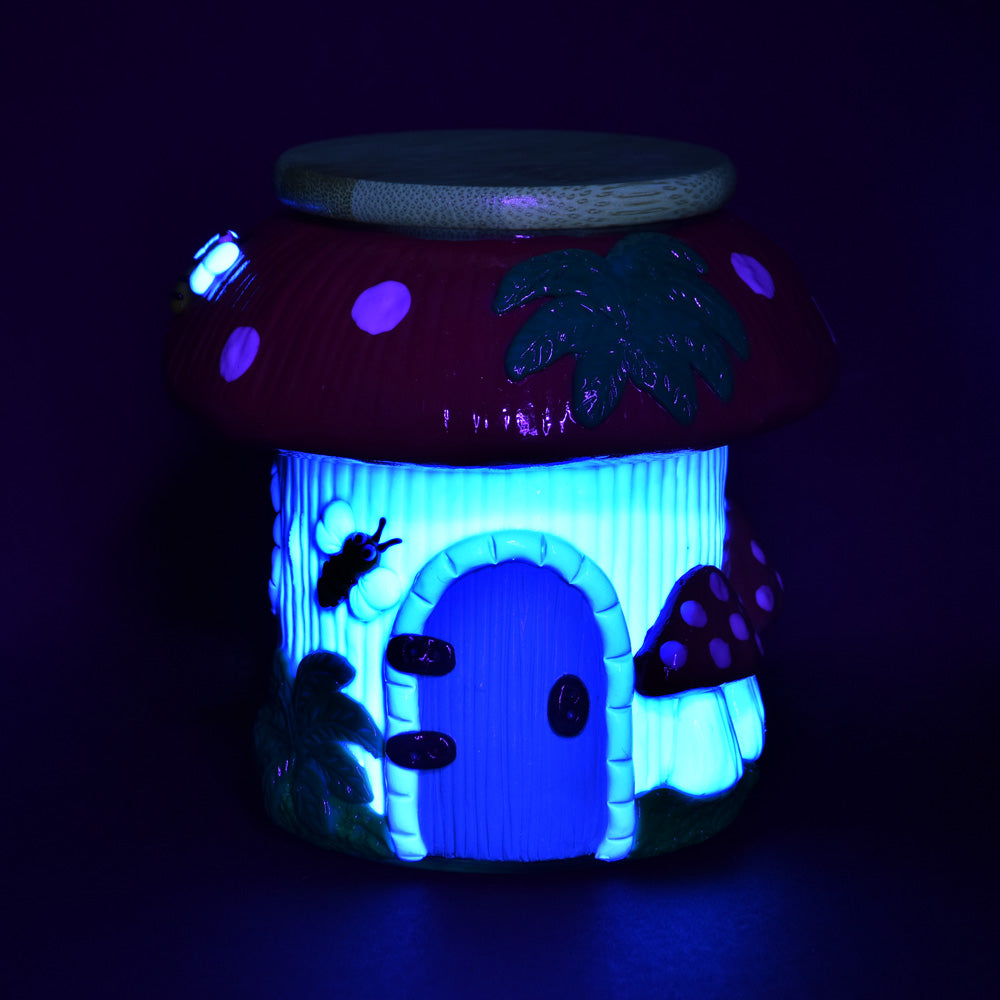 Pulsar Shroom Cottage Glass Jar, 4.25" with glowing blue light, front view on a dark background