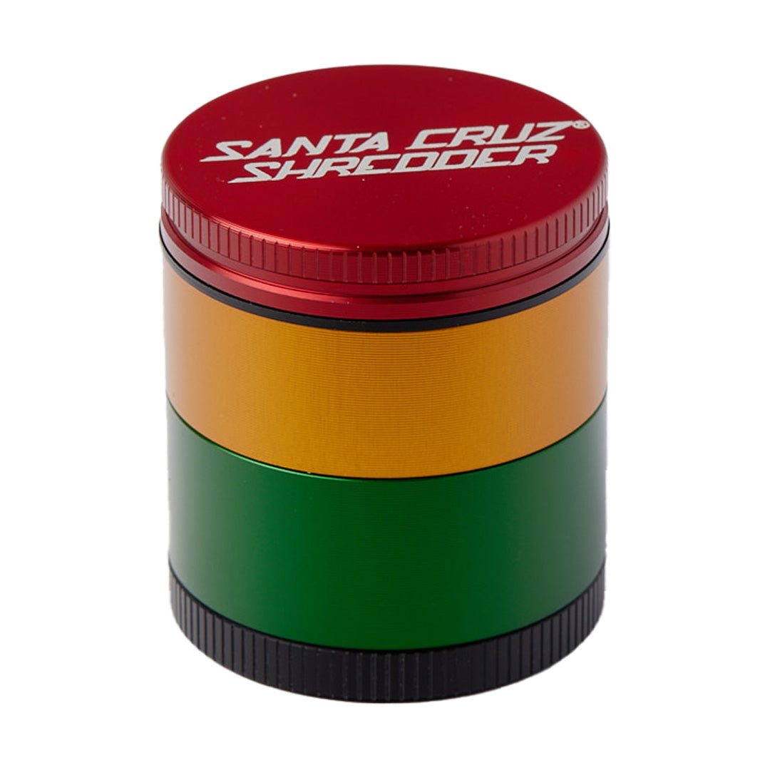 Santa Cruz Shredder Medium 4-Piece Grinder in Rasta colors, portable aluminum design, front view on white background