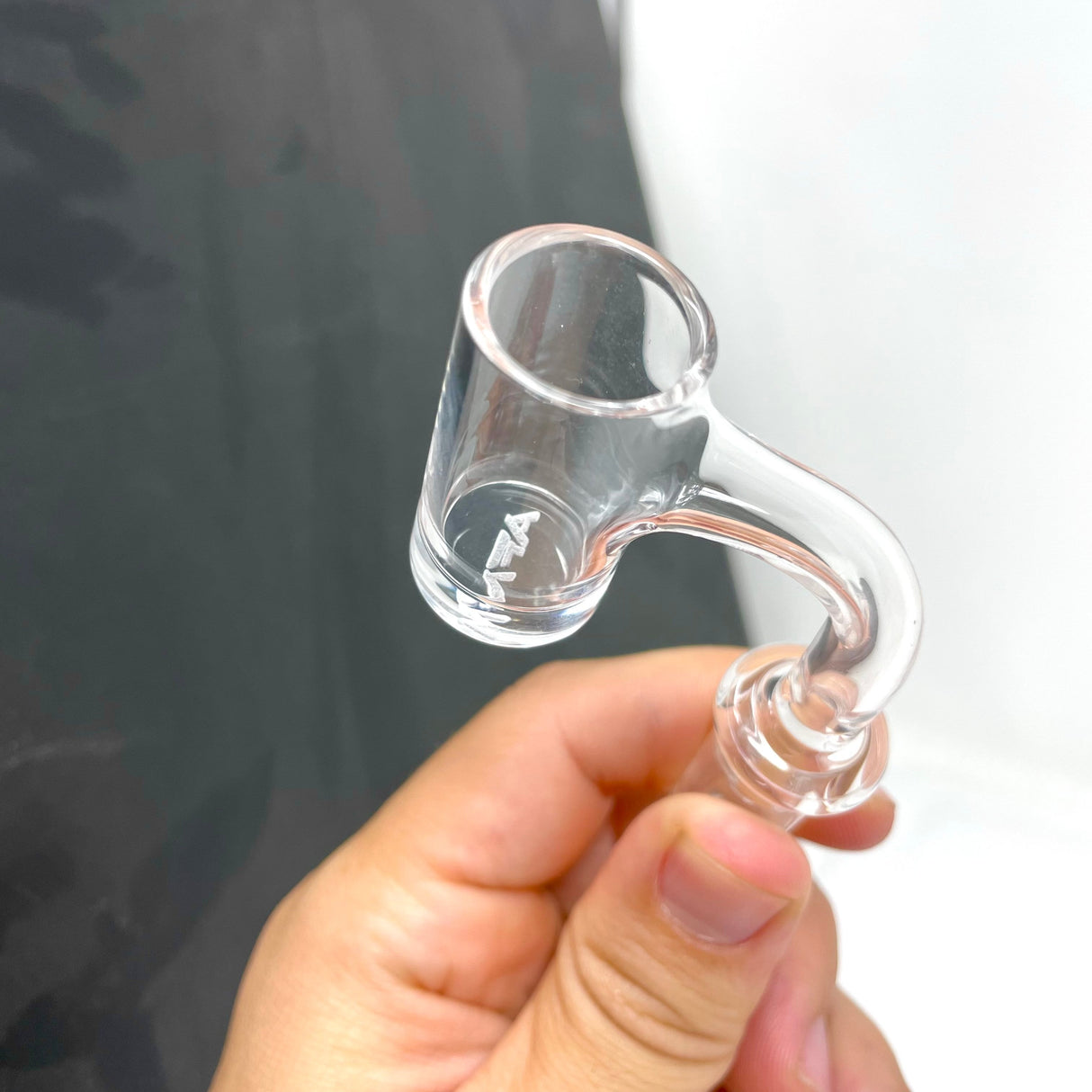AFM Full Weld Quartz Banger held in hand, 2mm thick 20mm bottom, clear view on grey background