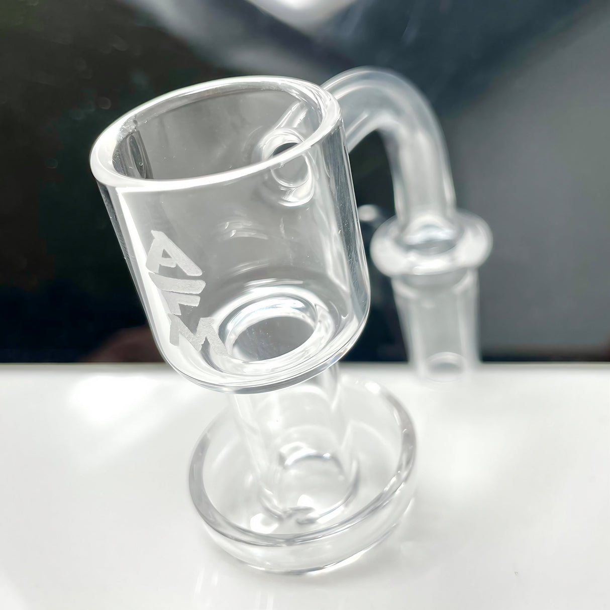 AFM Terp Slurper 25mm Quartz Banger Hanger, Side View on Reflective Surface