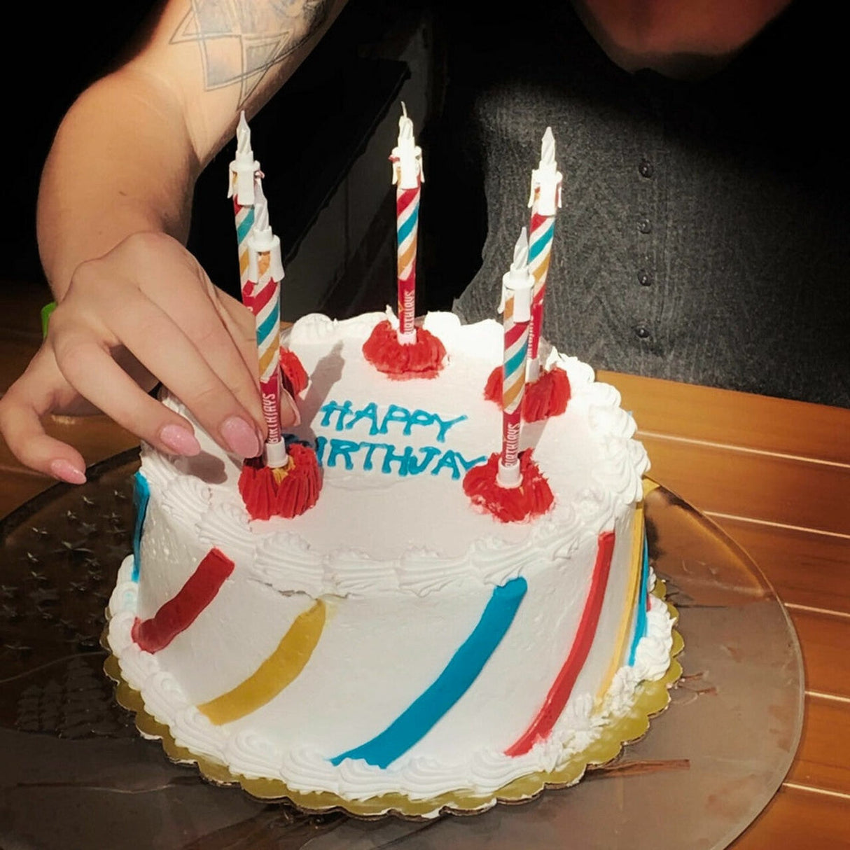 Close-up of a birthday cake with BirthJays joint holders as candles, ready for celebration