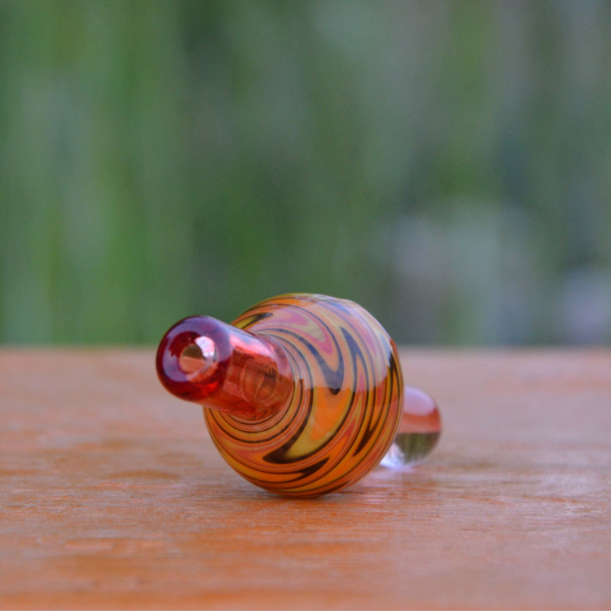 Calibear Wigwag design bubble carb cap for dab rigs, 25-30mm borosilicate glass, on wood