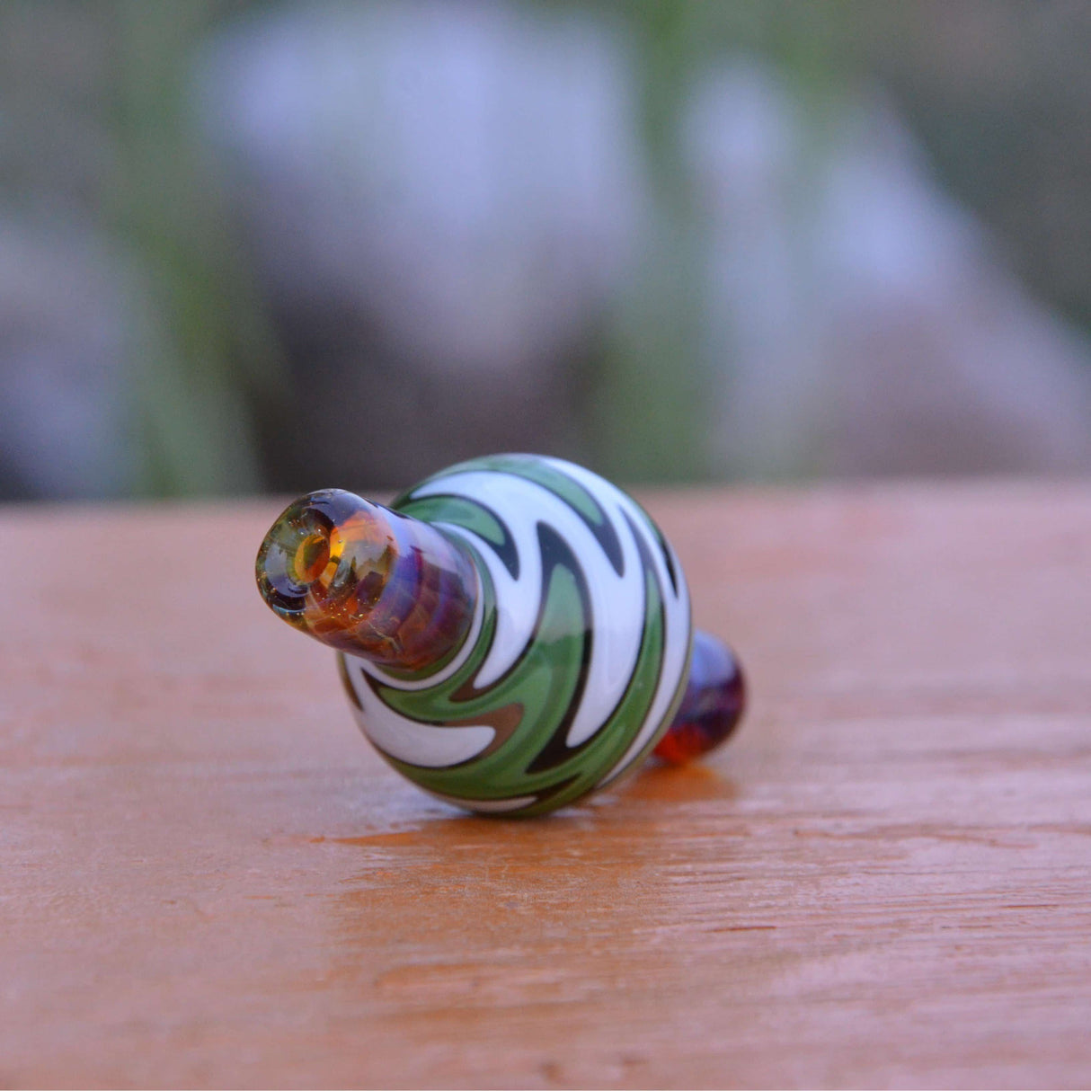 Calibear Wigwag Bubble Carb Cap, high-quality borosilicate glass, angled side view on wood