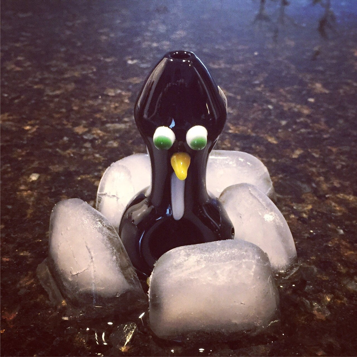 Chameleon Glass Chilly Willy hand pipe, front view surrounded by ice cubes, borosilicate glass.