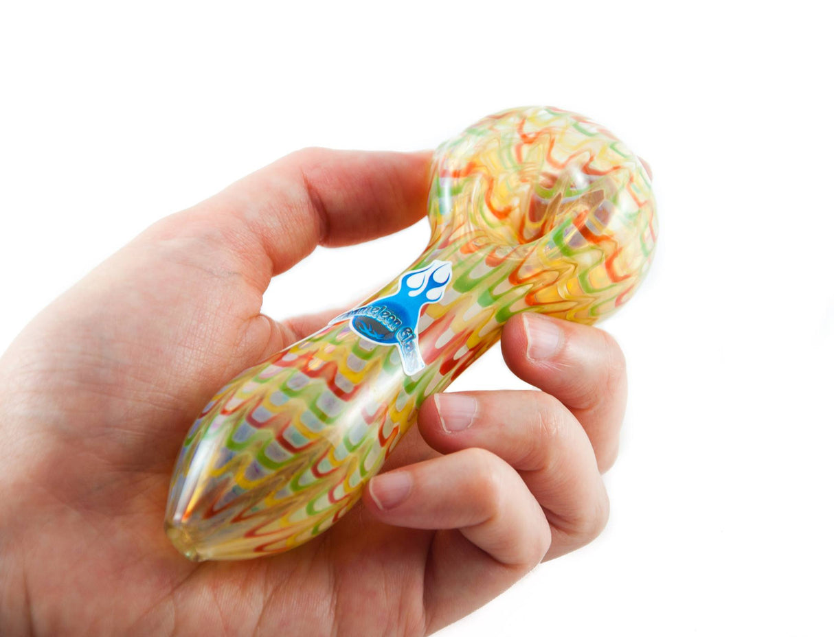 Chameleon Glass Perfect Storm hand pipe with Rasta color change held in hand