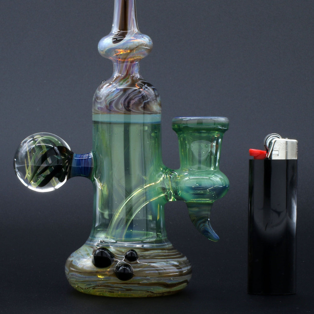 Clayball Glass "Enclave Nebula" Heady Sherlock Dab-Rig with intricate design, side view next to lighter