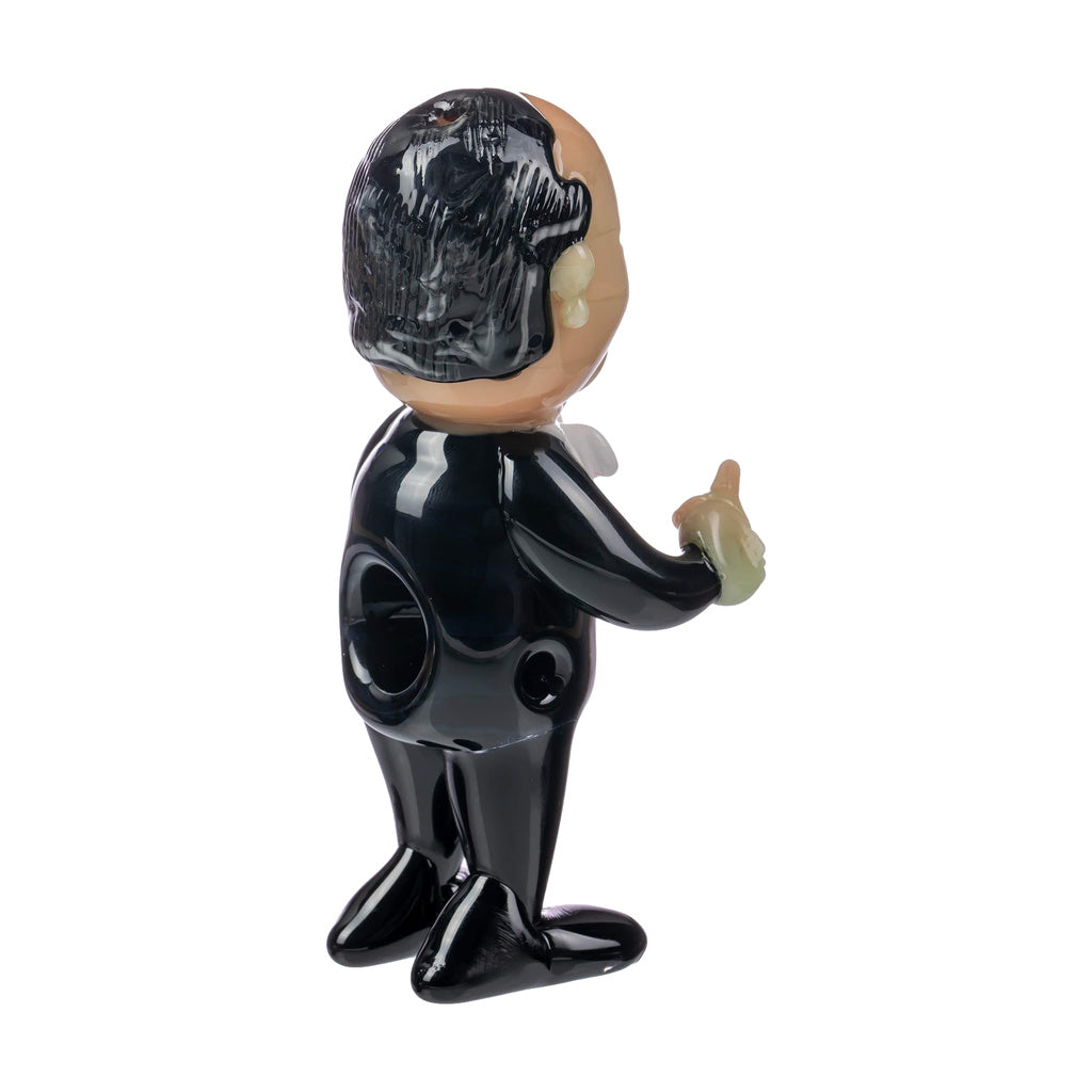 Empire Glassworks hand pipe with a caricature design, heavy wall, for dry herbs, side view.