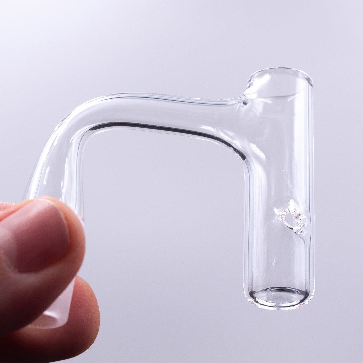 The Stash Shack Full Weld Finger Quartz Banger held in hand - Clear, Durable Design
