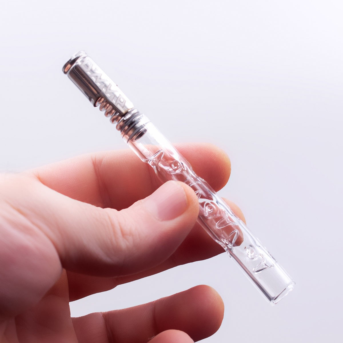 Hand holding a Glass XL Cooling Stem for DynaVap by The Stash Shack, clear view of intricate design