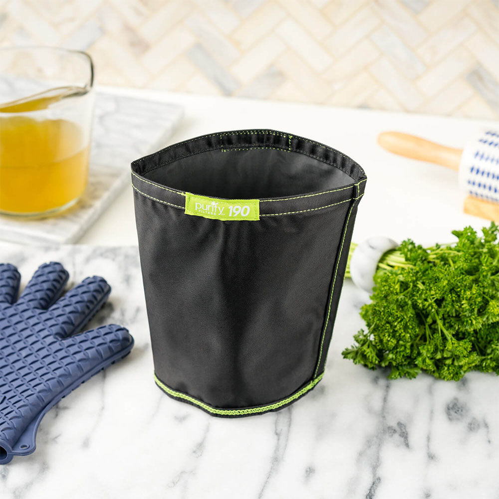 Magical Butter MB2e 40oz Botanical Extractor on marble countertop with herbs