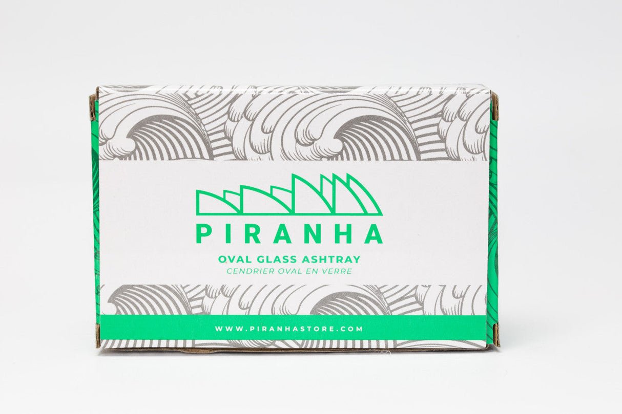 Piranha Glass Oval Slant Ashtray packaging front view on a seamless white background