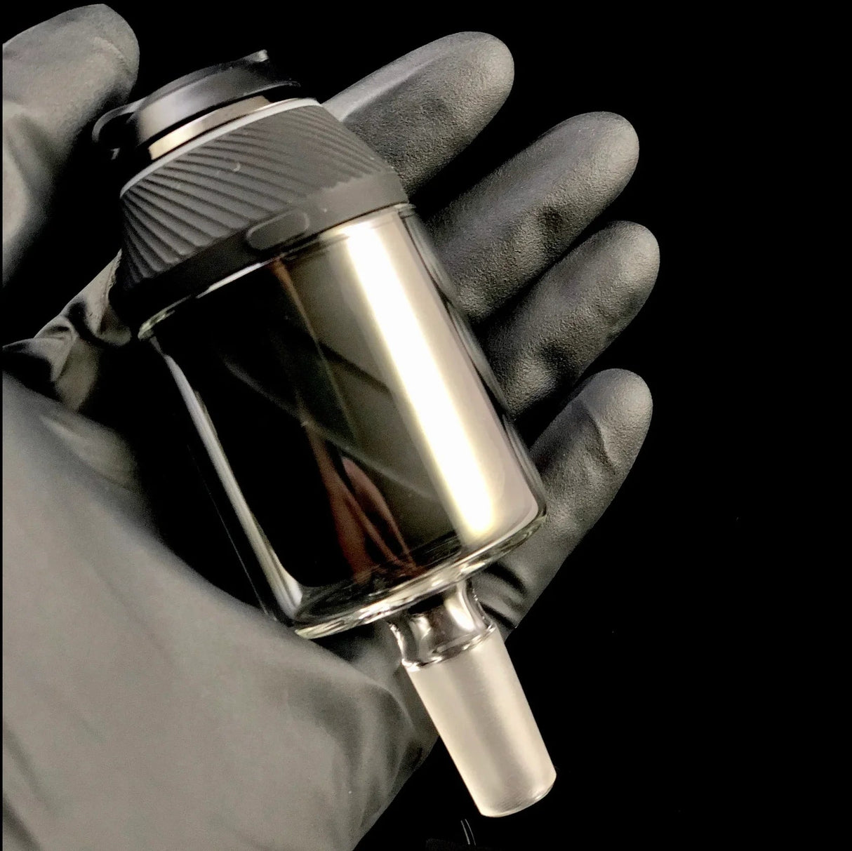 The Stash Shack Proxy Glass Adapter for concentrates, held in hand, angled view