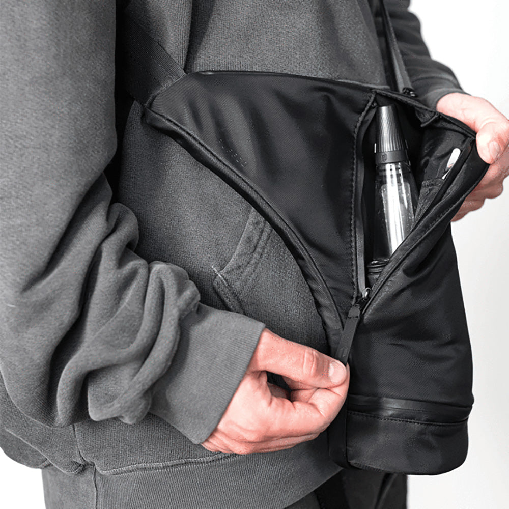Person holding Puffco Journey Travel Bag open to show Peak vaporizer storage