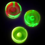 Pulsar Basic Tap Tray Ashtrays in neon colors glowing in the dark, top view, 4-inch silicone