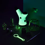 Pulsar RöK Electric Dab Rig glowing in the dark, complete with accessories, front view