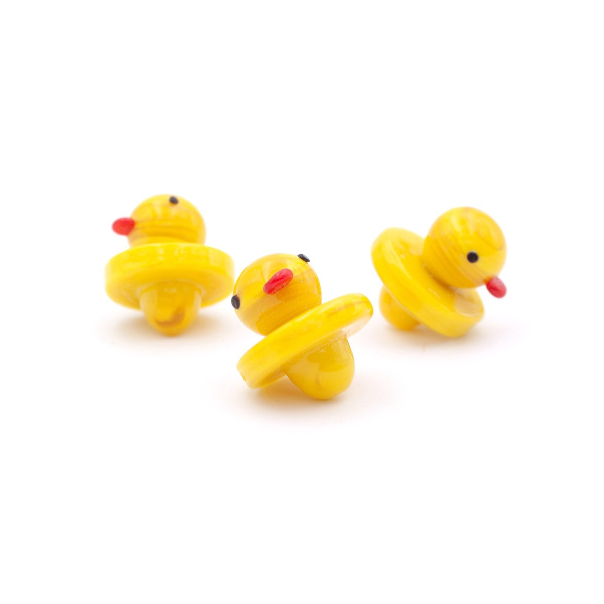 Rubber Duckie UFO Carb Caps by The Stash Shack, three yellow duck-shaped caps for dab rigs on white background