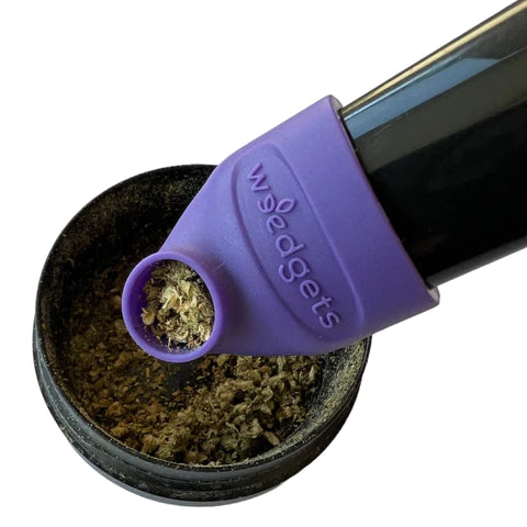 Weedgets Sili-Scoop Herb Loader in purple, touch-free design, shown with dry herbs and pipe