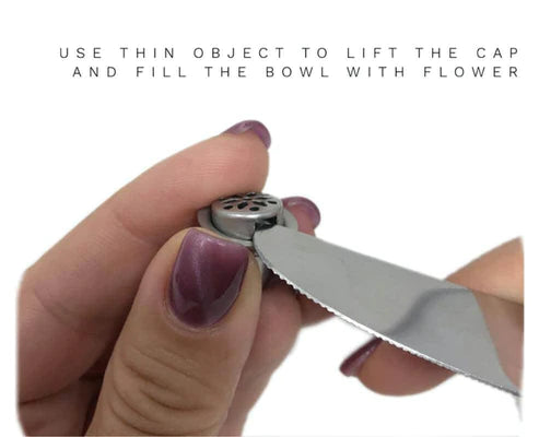 Weedgets Slider Pipe in use, showing how to lift cap with tool for filling, close-up on hand
