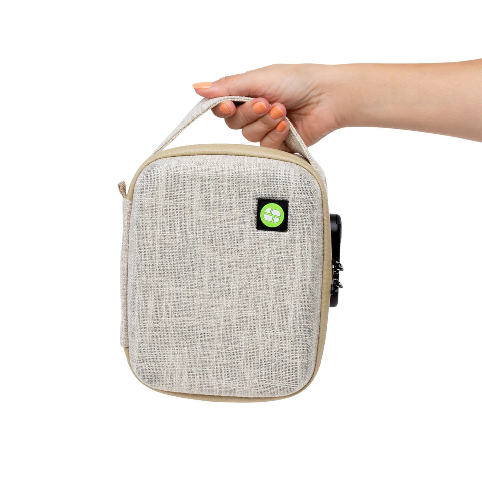 Hand holding Stashlogix Silverton Lockable Stash Case in Tan V2, front view on white background