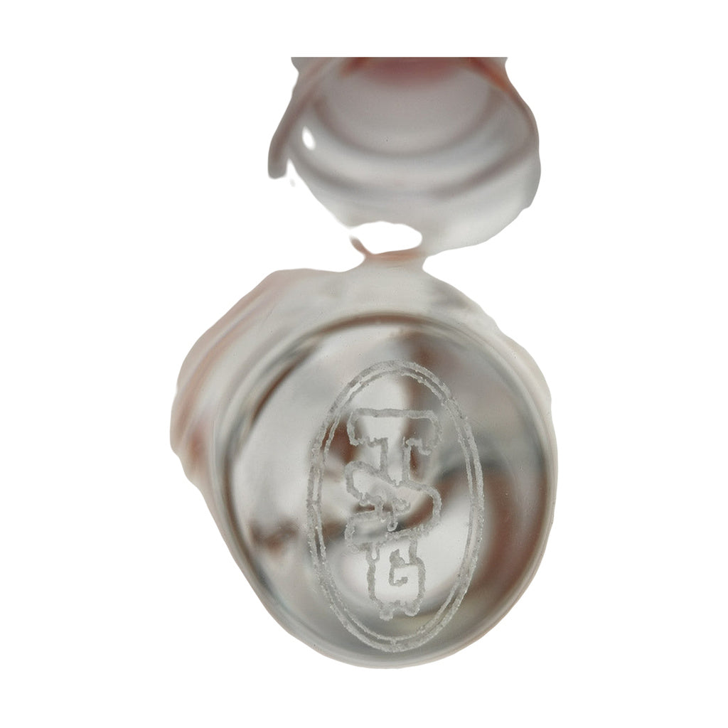 Close-up of TAG logo on 24" Beaker Bong made by Thick Ass Glass, showcasing heavy wall thickness.