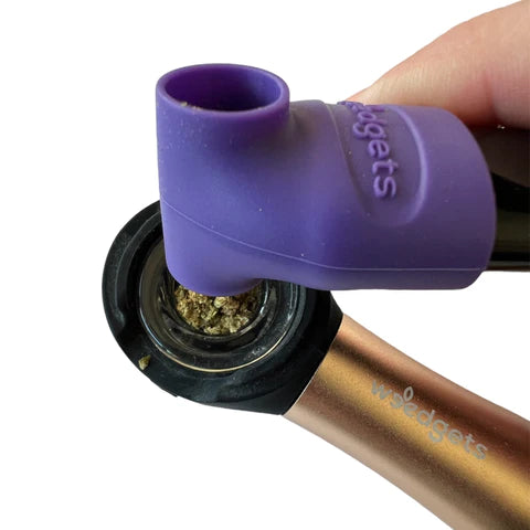 Weedgets Sili-Scoop in purple, touch-free herb loader & tamping tool, close-up on pipe
