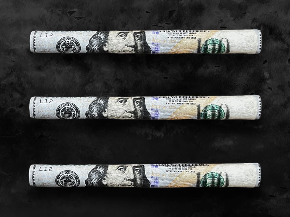 CaliGreenGold 100 Dollar Benny Hemp Blunt Rolls, 3-pack with filter tip, on a black background