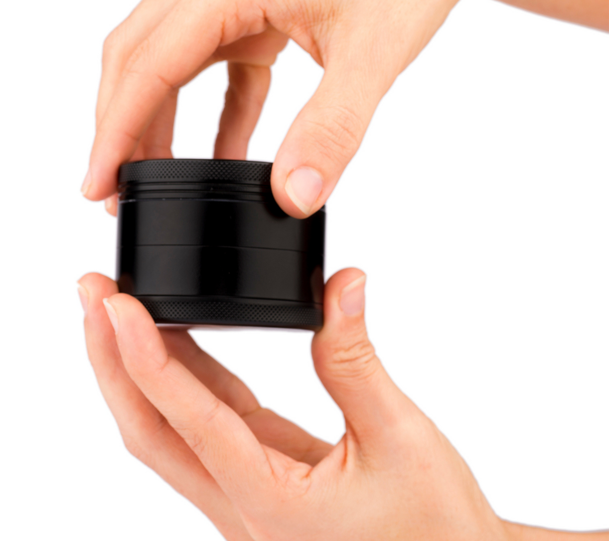 Hands holding a Z1 2.5" Black Ceramic Grinder by Blue Bus, compact and portable design