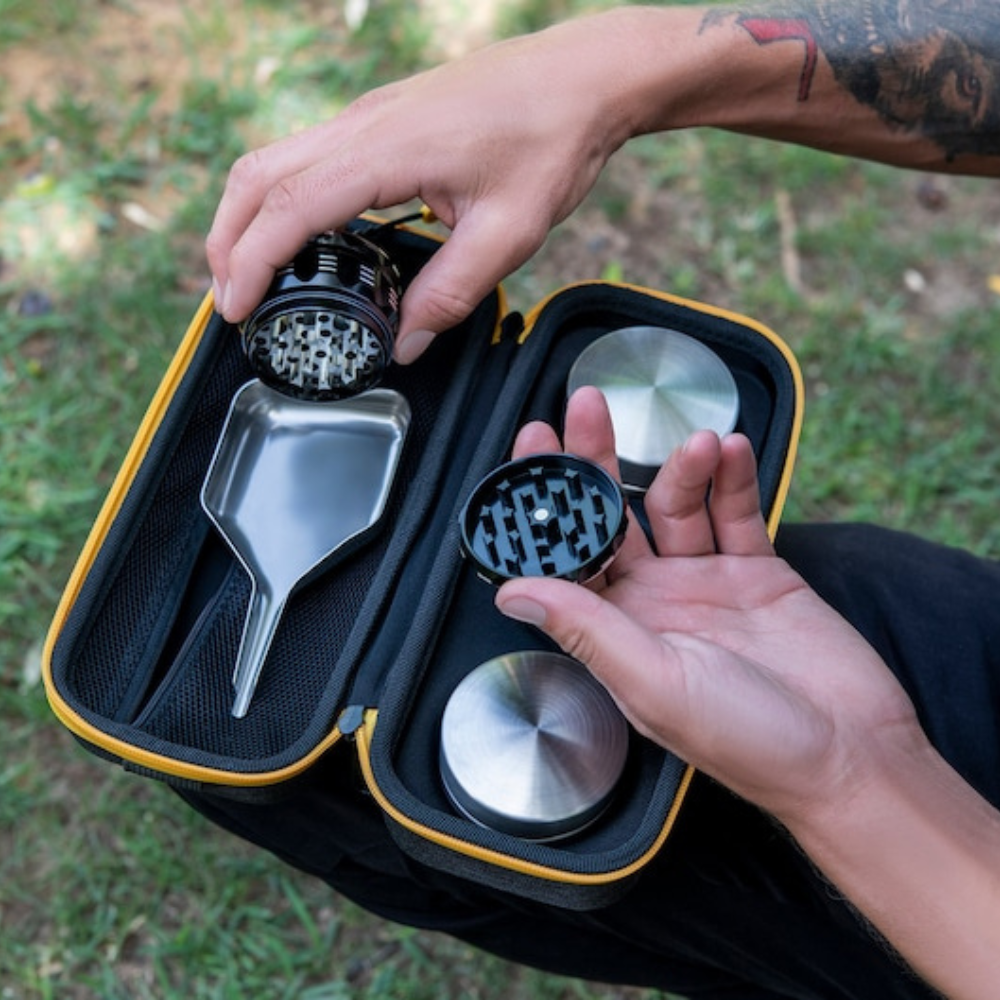 Compact TIGER pre-rolled cone loader kit with steel tools, shown in open case, outdoor setting