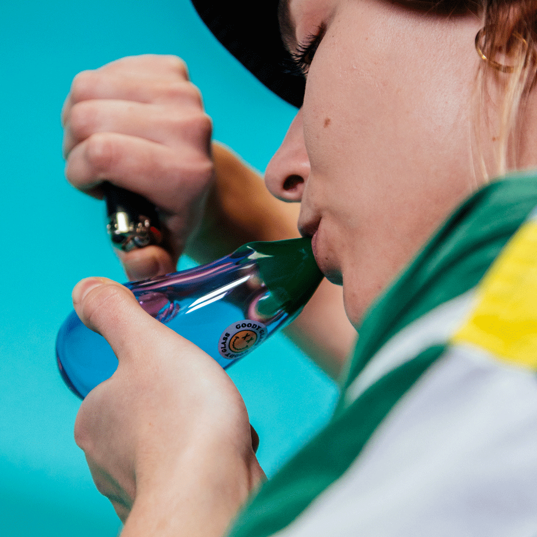 Person using Goody Eggplant Hand Pipe by Goody Glass, close-up side view