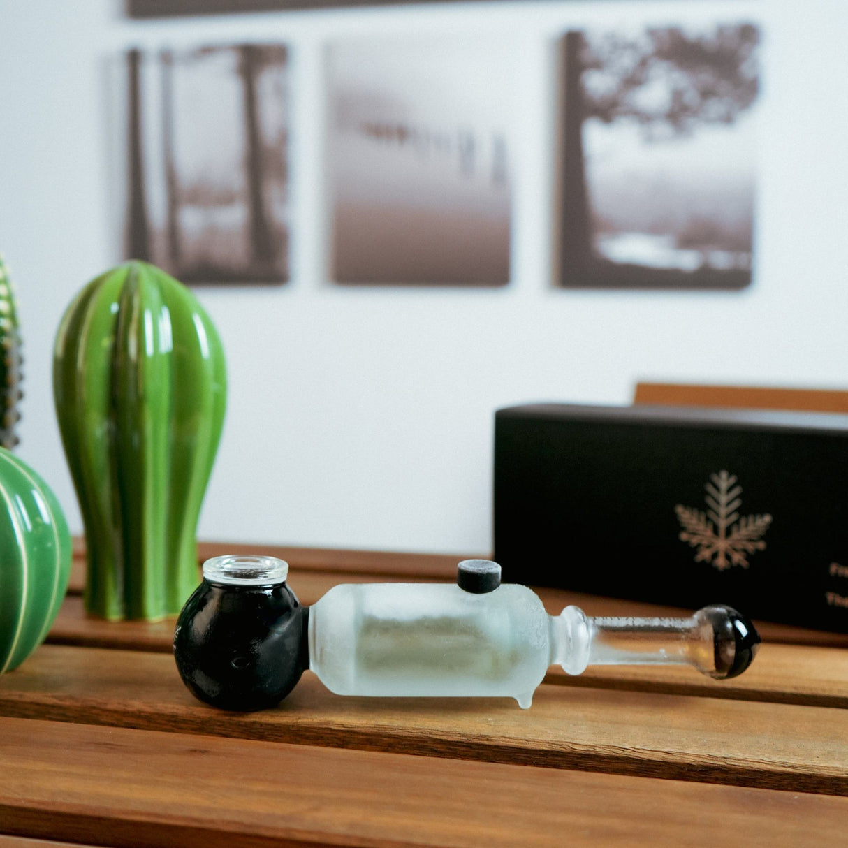 Freeze Pipe Revolver on wooden surface, side view, with frosted chamber and black accents
