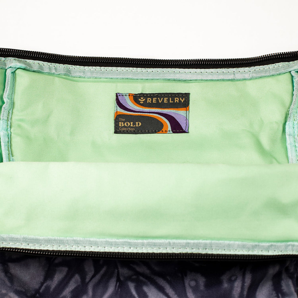 Close-up view of The Drifter backpack's interior with Revelry Supply label