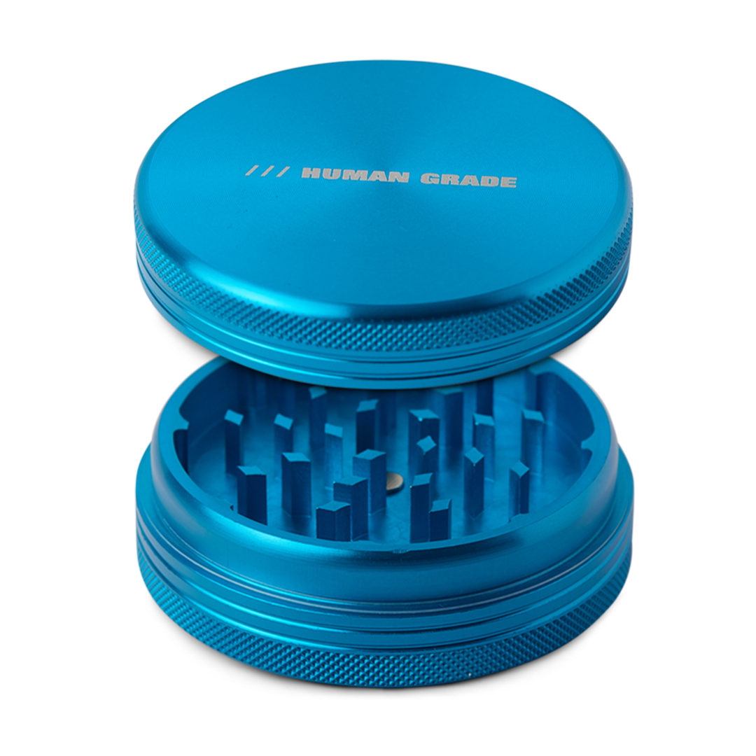Human Grade Grinder 1C in vibrant blue, 2.5" 2-Piece with sharp teeth, top view on white background