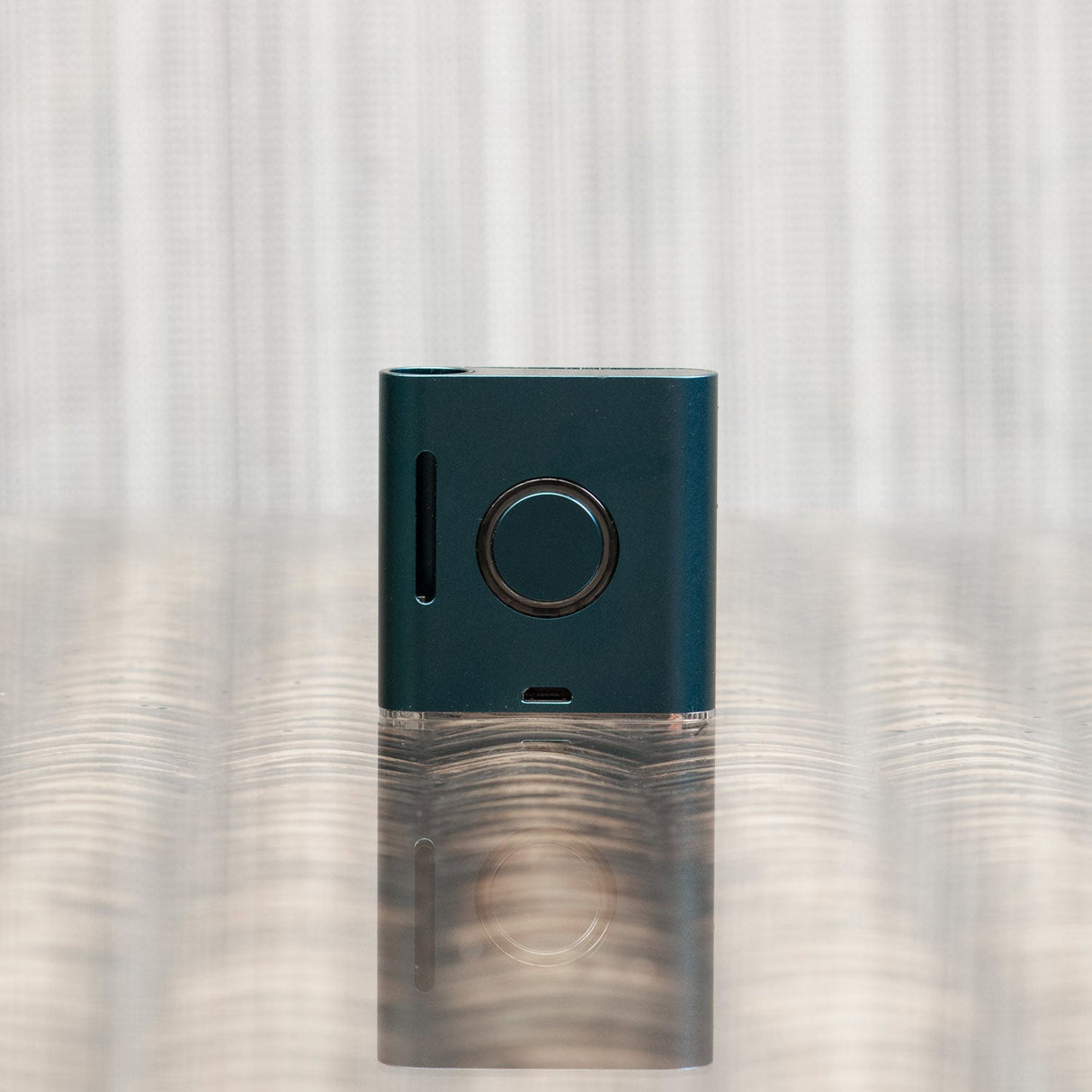 Helio Supply SolPod Express Kit in Navy Blue, compact vaporizer front view on reflective surface