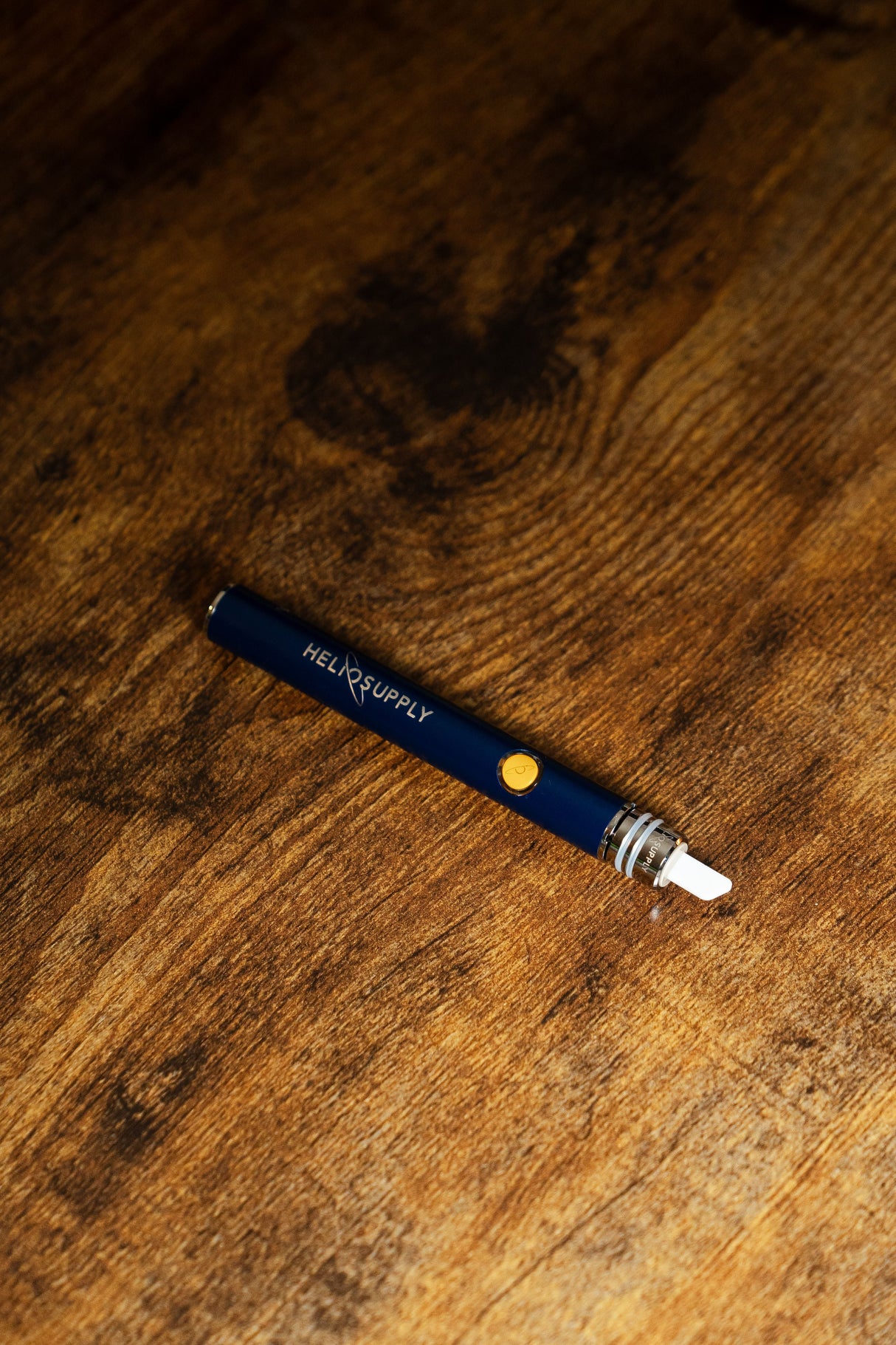 Helio Supply Budder Knife, Electronic Dab Tool with Ceramic Attachment on Wooden Surface