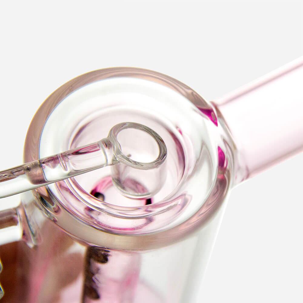 Close-up of PILOT DIARY Hephaestus Swing Arm Dab Rig with clear glass and pink accents