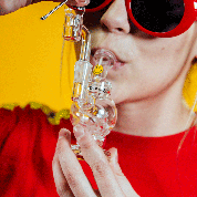 Person using Goody Glass Orbit Mini Rig 4-Piece Kit, clear glass, portable size