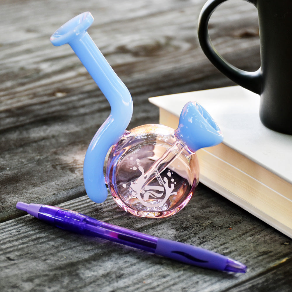 Pulsar Mini Travel Fixed Bowl Water Pipe in blue, angled view on wooden surface