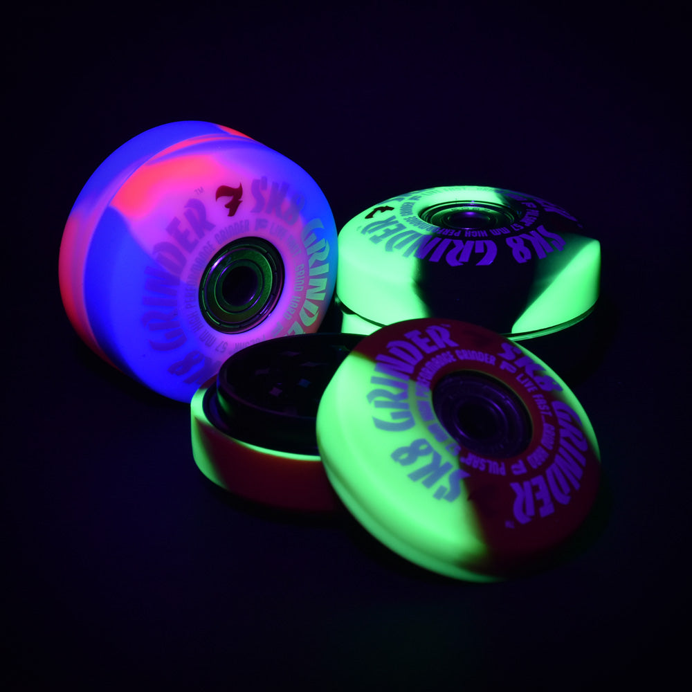Pulsar SK8 Grinder Set in Swirl Colors glowing under black light, 3-piece metal design